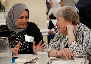 Mehtap Abusalim talks with Marilyn Beliveau during the 21st annual Catholic-Muslim iftar dinner at the Mecca Center in Willowbrook on May 25, 2018. (Karen Callaway/Chicago Catholic)