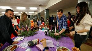 Steve and Kara Johnson and Andy and Kerry Gallios make an Advent wreath with their children. (Karen Callaway/Chicago Catholic)