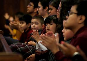 Students clap at the end of Mass. (Karen Callaway/ Chicago Catholic)