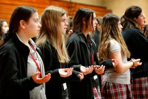 Students pray the Our Father during Mass. (Karen Callaway/Chicago Catholic)