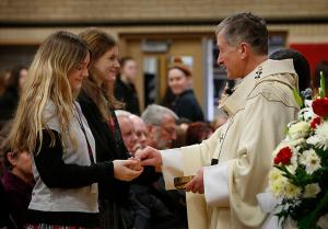 Cardinal Cupich gives Communion to Resurrection students. (Karen Callaway/Chicago Catholic)