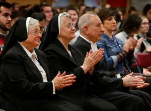 Sisters of the Resurrection and Christian Brother Michael Fehrenbach, provincial superior of the Christian Brothers of the Midwest, applaud following Mass. (Karen Callaway/Chicago Catholic)