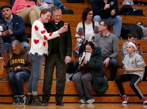 Cardinal Cupich stops to meet families and take selfies during halftime. (Karen Callaway/Chicago Catholic)