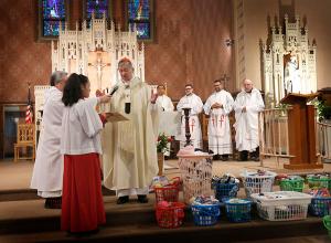 Cardinal Cupich blesses items donated by students to the Olive Branch Mission. (Karen Callaway/Chicago Catholic)