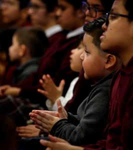 Students clap following a presentation of items they donated to the Olive Branch Mission. (Karen Callaway/Chicago Catholic)