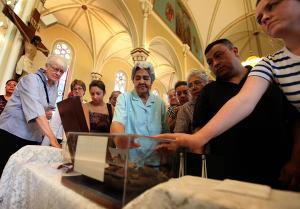 Hundreds of people line up to venerate then-Blessed Mother Teresa of Kolkata's sandals following Mass at St. Procopius Church in Chicago on July 17, 2010. Two first-class relics and some items belonging to Mother Teresa such as the sandals and a rosary were in Chicago for the weekend to celebrate the 100th birthday of the sainted Albanian nun. (Karen Callaway/Catholic New World)