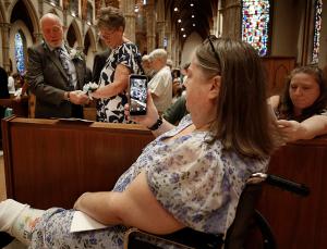 Thomas and Kathleen Huber from Holy Family Parish in Inverness renew their vows during Mass while their daughter Nicole records them. (Karen Callaway/Chicago Catholic)