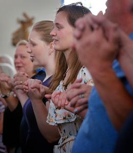 Parishioners pray the Our Father during Mass at St. Hugh. (Karen Callaway/Chicago Catholic)