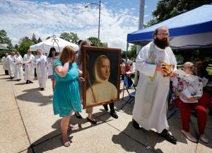 Father Matt Nemchausky, pastor of Mater Christi Parish, leads the procession before the dedication of the St. Hugh Faith Formation Center at Mater Christi. (Karen Callaway/Chicago Catholic)