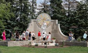 Parishioners place flowers at the Mother of Mothers Shrine at the Mater Christi worship site. (Karen Callaway/Chicago Catholic)