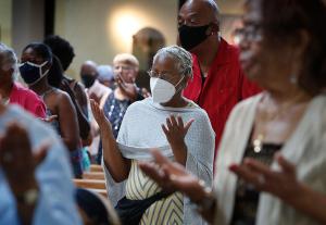 Worshipers hold their hands out in prayer during Mass. (Karen Callaway/Chicago Catholic)