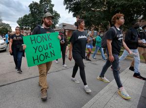 People hold signs while walking through Auburn-Gresham. (Karen Callaway/Chicago Catholic)