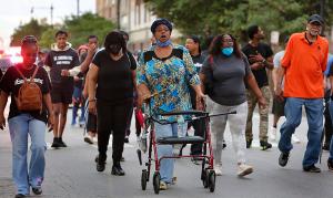 People chant while walking through Auburn-Gresham. (Karen Callaway/Chicago Catholic)