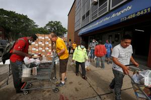 Volunteers assist guests in loading their shopping carts. (Karen Callaway/Chicago Catholic)