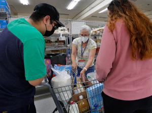 Bev Haramis helps guests with a bread selection. (Karen Callaway/Chicago Catholic)