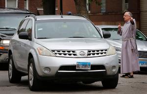 Bishop Bob Lombardo directs traffic during the food pantry. (Karen Callaway/Chicago Catholic)