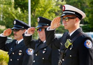 Members of the Orland Park Fire Department salute as the American flag is lowered. (Karen Callaway/Chicago Catholic)