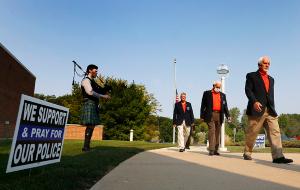 Members of the Knights of Columbus walk past Brenda Siemiawski who is playing Amazing Grace. (Karen Callaway/Chicago Catholic)