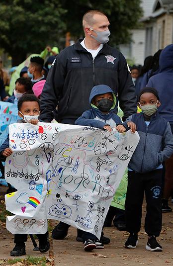 Chicago police officers join students during the march. (Karen Callaway/Chicago Catholic)