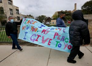 Students and staff made signs to carry in the walk. Teachers and volunteers joined students in the walk. (Karen Callaway/Chicago Catholic)