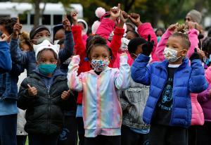 Students gesture during the song “My God is an Awesome God” at the end of the march. (Karen Callaway/Chicago Catholic)