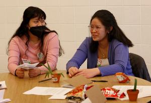 Rebecca Guerra from Trinity High School and Paige Natindim from St. Viator discuss topics related to the environment in their break-out group. (Karen Callaway/Chicago Catholic)