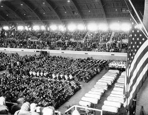 Over 7,000 packed Northwest Armory for children's requiem Mass in which Archbishop Albert G. Meyer officiated. Twenty-seven white coffins lined up before a temporary altar. Individual funerals were held at a later date. (Chicago Catholic file photo)