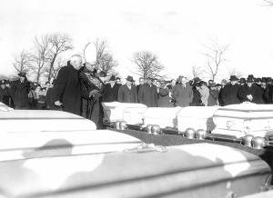 Accompanied by Msgr. Francis McElligott, archdiocesan director of cemeteries, Bishop Hillinger blesses caskets at Queen of Heaven Cemetery in Hillside.  (Chicago Catholic file photo)