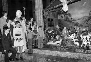 THEN: During Midnight Mass in 1976, Cardinal John Cody and some children view the Nativity scene at Holy Name Cathedral. (Chicago Catholic file photo)