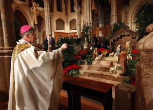 NOW: Then-Archbishop Cupich incenses the creche at the beginning of Midnight Mass at Holy Name Cathedral 2014. It was his first Midnight Mass as the new archbishop of Chicago. (Karen Callaway/Catholic New World)