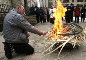 NOW: David Sokolowski burns palms from the previous year during a Shrove Tuesday service, Feb. 5, 2008, at the cathedral. (Karen Callaway/Chicago Catholic)