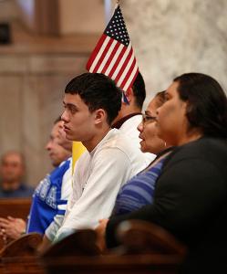 A young man kneels in prayer during Mass. (Karen Callaway/Chicago Catholic)