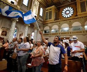 Participants dress in their country's colors and wave the national flag during Mass. (Karen Callaway/Chicago Catholic)