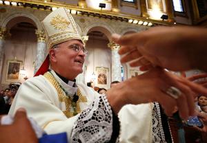 Bishop Báez shakes hands with people as he leaves the church. (Karen Callaway/Chicago Catholic)