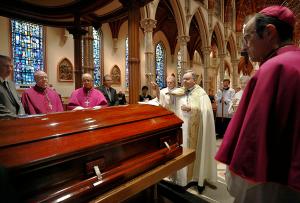 Auxiliary Bishop Robert Casey blesses the casket of Auxiliary Bishop Kevin Birmingham during the Rite of Reception at Holy Name Cathedral on Oct. 6, 2023. (Karen Callaway/Chicago Catholic)