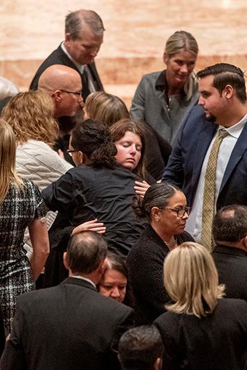 Members of Bishop Birmingham's family share the sign of peace during the funeral Mass on Oct. 7, 2023, at the cathedral. (Deacon Randy Belice/Chicago Catholic)