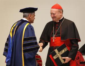 Miguel H. Díaz, Loyola University Chicago's John Courtney Murray Chair in Public Service, greets Cardinal Gianfranco Ravasi at the Madonna della Strada Chapel at Loyola University in Chicago on March 25. Cardinal Ravasi, the president of the Pontifical Council for Culture and the Pontifical Commission for Sacred Archeology, received an honorary doctorate from Loyola and delivered a talk on Catholic university and American culture. (Karen Callaway/Catholic New World)