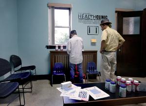 People fill out forms in the waiting room at the clinic. (Karen Callaway/Chicago Catholic)