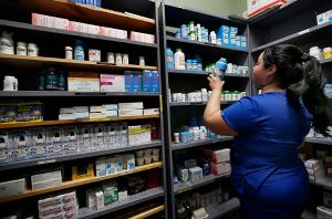 Ramirez checks gets medicine from the small on-site pharmacy. (Karen Callaway/Chicago Catholic)