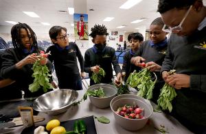 The students prep radishes for cooking. Students at Chicago Jesuit Academy, 5058 W. Jackson Blvd., take part in a culinary arts class with Chef Sebastian White on Jan. 27, 2025, as part of the school's co-curricular program. Through the class, which the students select from a host of offerings, the students learn how to prepare different dishes, how to properly slice vegetables, how to season dishes and more. The culinary arts co-curricular class has been one of the school's most popular since it began. (Karen Callaway/Chicago Catholic)