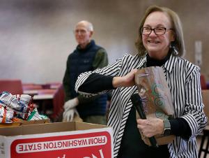 Carolyn Murphy from Uncle Pete’s Ministry explains to students how to assemble a lunch. During Catholic Schools Week, the student body (pre-k-8th grade) at St. Ferdinand School teamed up with Uncle Pete's Sandwich Ministry to pack food bags for the homeless on Jan. 27, 2025. Seeing a need, Pete Zonsius, known as Uncle Pete, organized his St. John Brebeuf community in Niles to make sack dinners once per month for eight months of the year. Today, the ministry has many churches and groups including sports teams, scouts, guilds and youth groups, public and private schools, individuals hosting sack making parties, as well as businesses, all making sacks for soup kitchens and food pantries, shelters and housing facilities, women and children and senior programs. (Karen Callaway/Chicago Catholic)