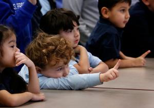 Students hold up one finger in response to a question. (Karen Callaway/Chicago Catholic)
