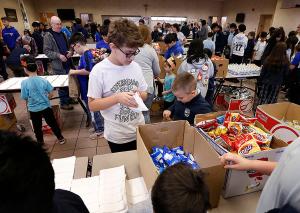 Students from different grades work together to pack lunches. (Karen Callaway/Chicago Catholic)