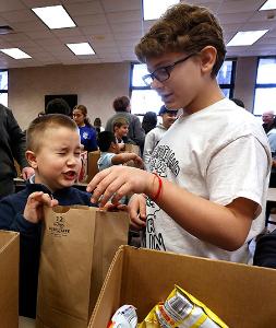 Students work together to assemble bags. (Karen Callaway/Chicago Catholic)