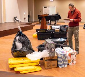 John Goebelbecker consults a list of donations. (Denise Duriga/Chicago Catholic)