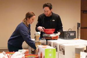 Megan Scully and Nate Schaefer sort donations. (Denise Duriga/Chicago Catholic)
