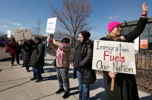 Wearing a pink hat, Rosa Alaniz, Elvad Gayton and Janet Gavina join members of Sisters and Brothers of Immigrants support migrants with a public witness on March 1, 2025, at 39th Street and Archer Avenue in Chicago. (Karen Callaway/Chicago Catholic)