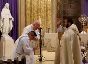 Father Carrillo blesses Deacon Victor Uruchima and Deacon Charley Shallcross at the start of the prayer service inside the church. (Karen Callaway/Chicago Catholic)