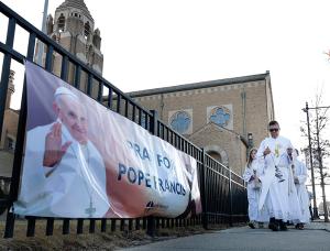 Deacon Uruchima leads a procession from the church to the front of the school. (Karen Callaway/Chicago Catholic)