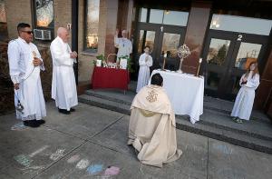 Deacons Uruchima and Shallcross assist Father Carrillo outside the school. (Karen Callaway/Chicago Catholic)